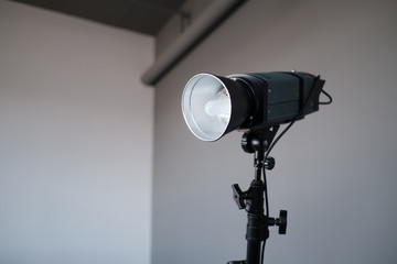 Impulse studio flashlight on the grey wall background.