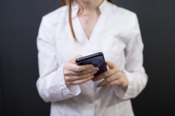 Young female doctor with phone
