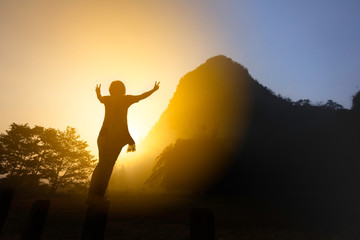 Silhouette woman hand up expression happy before start hiking trip