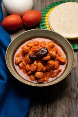 Mexican sausage with chipotle sauce on wooden background