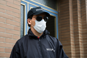 Security Guard Standing In Face Mask