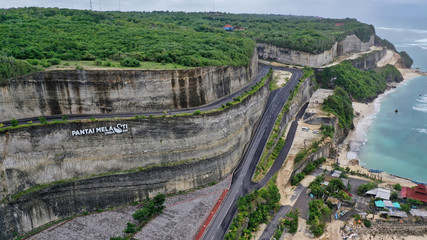 top view of the winding road leading to one of the most beautiful beaches in Bali Melasti Beach