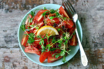 Healthy vegan salad with tomatoes and microgreens. Food for weight loss. Vegan diet.