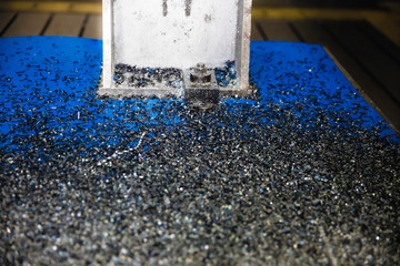 metal chip waste after machining metal parts on a cnc lathe. Closeup twisted spiral steel shavings