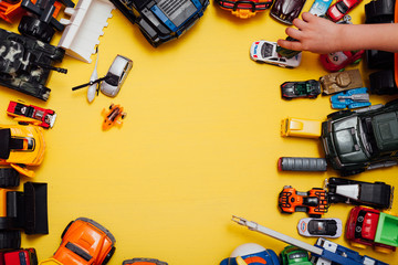 Lots of children's toy cars for child development games on a yellow background