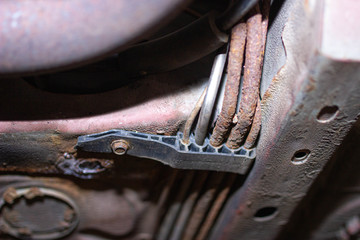 rusty brake and fuel pipes under the bottom of the car.