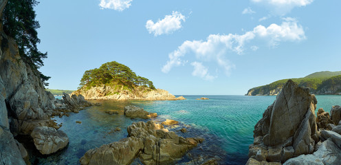 Fototapeta na wymiar Sea coast with clear water. Stones and sea urchins at the bottom.