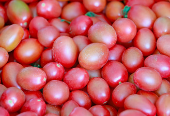 Many fresh tomatoes piled up together