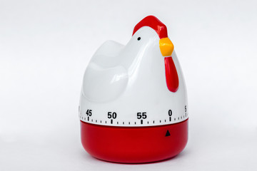 Kitchen timer in the form of chicken made of plastic on a white background. Clock for cooking. With...