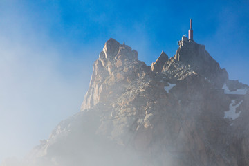 Aiguille du Midi in the fog and clouds in the French Alps, Chamonix Mont-Blanc, France