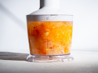 Step-by-step instructions for making smoothies from orange and carrots. Step 4. The concept of proper nutrition.