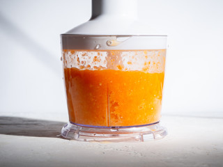 Step-by-step instructions for making smoothies from orange and carrots. Step 5. The concept of proper nutrition.