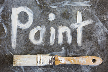 Paint and paintbrush for home renovation and improvement.