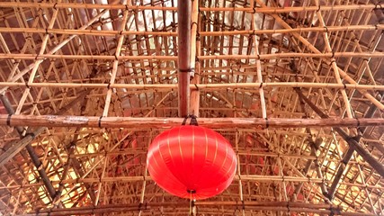 Low Angle View Of Red Lantern Hanging From Bamboo Scaffolding