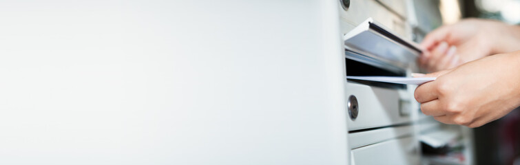 Woman putting envelope in mailbox