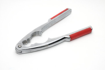Tongs for nuts on a white background