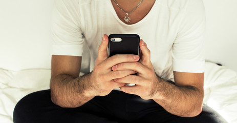 young man texting on his cellphone