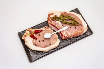 Raw pork steaks isolated on white background