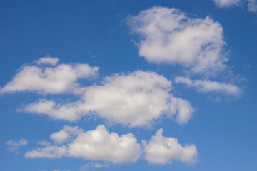 Naklejka na ściany i meble Bright blue sky with white clouds. Sunny day