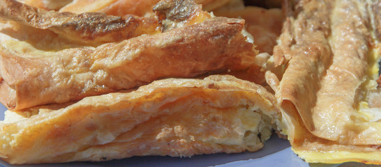 pieces of moldavian vertuta with cottage cheese close-up on a blue plate   