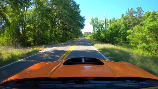 Orange sports car accelerating rapidly drag racing