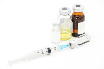 Coronavirus pandemic, people vaccination concept. Vaccine syringe with vials, medicines close up on white background .
