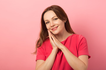 beautiful young woman with make-up on pink background