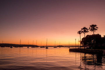 Fototapeta na wymiar orange dawn and yachts on the water