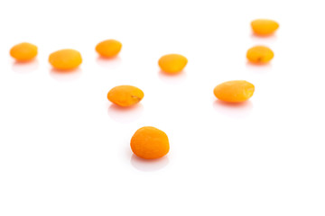 Grains lentils isolated on white. Row organic orange pea seeds background. Vegan lentil gluten-free organic, healthy vegetarian diet superfood with antioxidant, omega-3, protein, mineral nutrients.