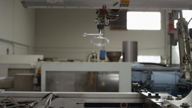 Injection molding machine with robotic arm in American manufacturing factory