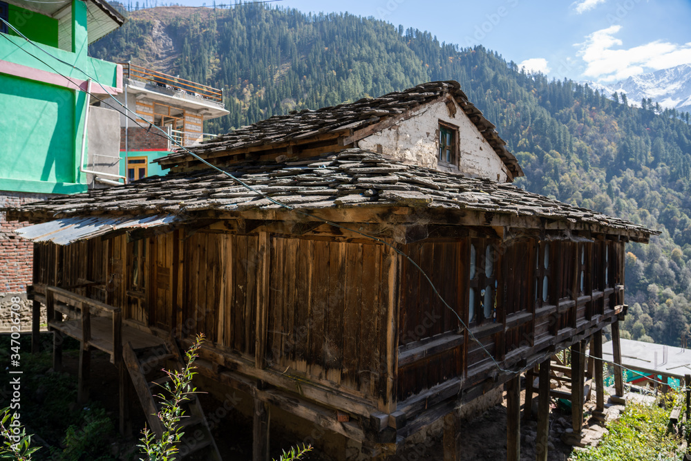 Poster old wooden and brick house in the mountains of india manali