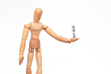 Wood figurine holding in one hand the word 