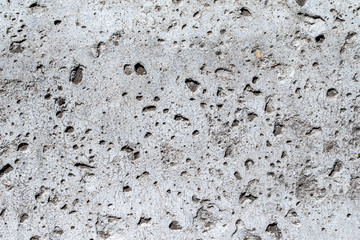 Background, texture, rough concrete wall, with cracks and holes.