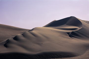 Fototapeta na wymiar Sunset in the desert dunes, in the oasis of Huacachina Peru. One