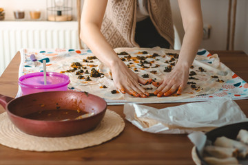 Fototapeta na wymiar Young woman making pastry with phyllo dough to learn new things is very hungry and Preparing delicious meals with their hands