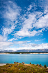 Beautiful day at Lake Pukaki, an alpine lake famous for the amazing turquoise hues of the water and the sharp mountain ranges surrounding it, in New Zealand, South Island.