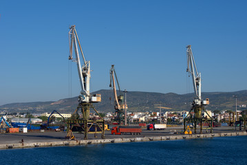 Fototapeta na wymiar Volos , Greece , 5/8/2020 . Mobile port cranes are loading scrap metal for recycling