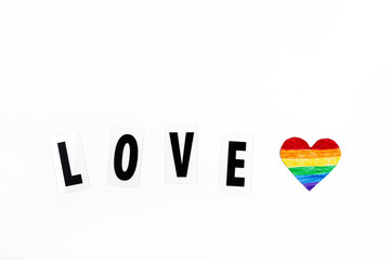 Mockup made with the LGBT pride flag with the heart coloured in LGBTQ pride colours. Concept of the Pride day, Valentine day, freedom, love. Flat lay, top view, template, overhead