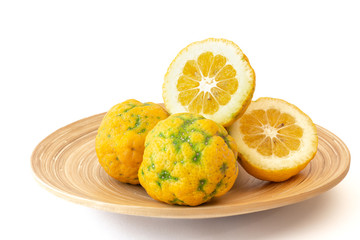 Citrus hybrid close up on a wooden plate, isolated on white background