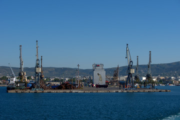 Fototapeta premium Volos , Greece , 5/8/2020 . Mobile port cranes are loading scrap metal for recycling