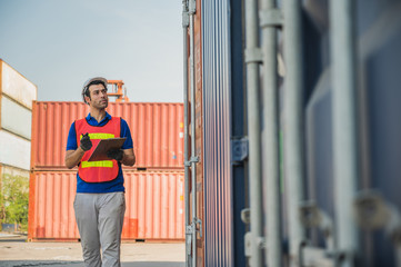 Foreman holding clipboard working at Container cargo harbor. Business Logistics import export shipping concept.