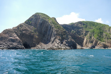 Fototapeta na wymiar Huge hexagonal columnar joints of volcanic rock at Hong Kong Global Geopark, China 