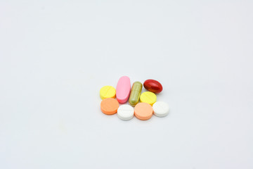 Obraz na płótnie Canvas The color of oral medicines on a white background, medicine pill pharmacy drug