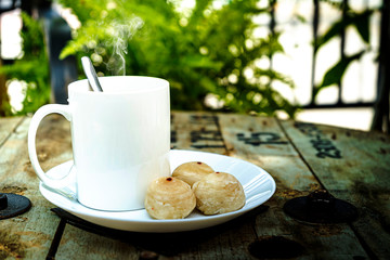 Hot Coffee with sweets on the table applied from a Cable reel.