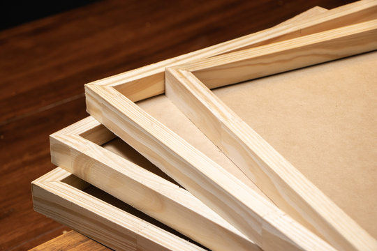 Stack of wooden frames on rustic table