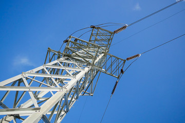 High voltage pole on blue sky background