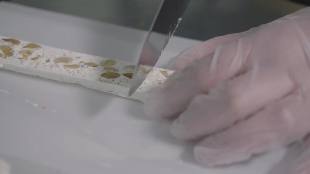 Slicing a piece of a torrone