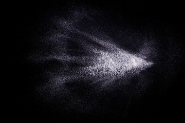 White powder explosion on black background.Stopping the movement of white powder on dark background. Launched white powder splash