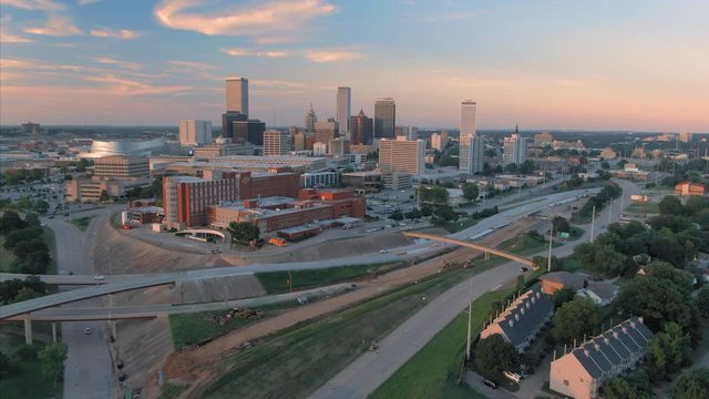 Tulsa, Oklahoma, USA. Aerial over the downtown city skyline and freeway at sunset