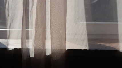 transparent pink tulle on a sunlit window
